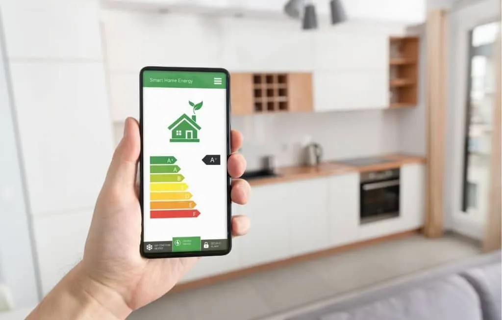 Hand holding a smartphone displaying high energy efficiency ratings, illustrating the benefits of energy-efficient windows and doors.